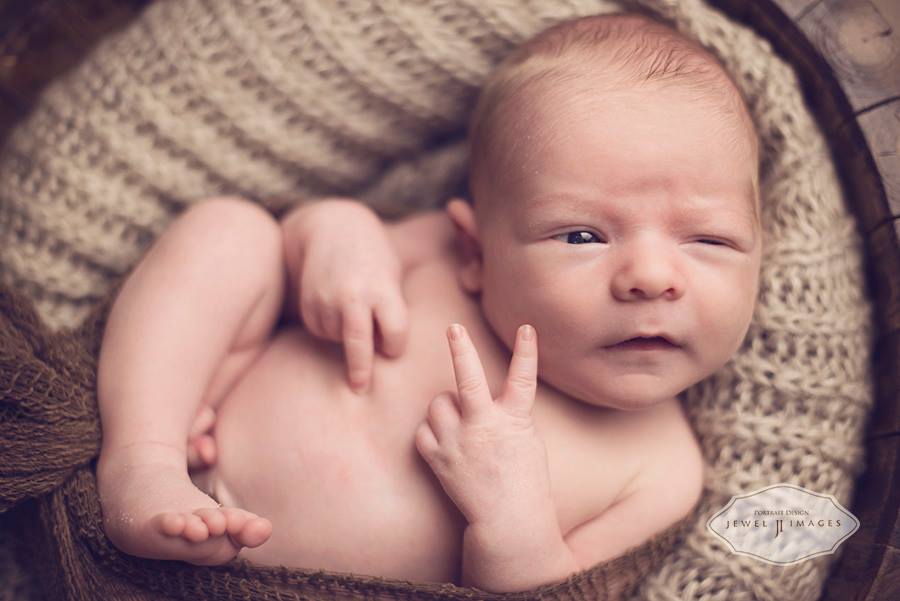 Baby Giving a Peace Sign Newborn Photography